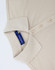 A beige ladies' classic cotton/poly pique short sleeve polo with a collar and buttons, featuring a branded label inside.