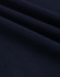A close-up of navy ultrafine cotton pique fabric, showcasing its texture and weave.