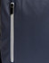 A navy backpack with a white zip pocket on the side, featuring a sleek design and a logo.