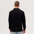 A black Studio Canvas Jacket displayed from the back, featuring a simple design and long sleeves.