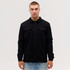 A black Studio Canvas Jacket features a collared design and front pockets, worn by a model against a plain background.