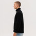 A black polar fleece full zip jacket displayed on a model. Features a high collar and a side view.