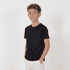 A youth black T-shirt with a simple design, worn by a young boy standing with his hands in his pockets.