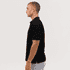 A black polo shirt displayed on a model, featuring a collar and short sleeves, with a logo on the chest.