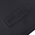 A black leather journal with a textured surface featuring a logo. The design is simple and elegant.