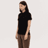A black women's polo shirt with a classic collar and short sleeves. The model is standing in a neutral pose.