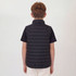 A black puffer vest with a high collar, viewed from the back, worn by a child with curly hair.