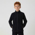 A youth full zip fleece jacket in black, featuring a stand-up collar and side pockets. It has a logo on it.