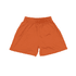 An orange pair of youth shorts with an elastic waistband and a simple design. It features a logo.