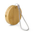 A round bamboo wireless charger with a grey strap, featuring a small port for connection.
