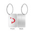 A metal luggage tag with a silver finish, featuring a red design on one side and a plain back.