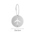 A circular silver luggage tag featuring a cut-out airplane design, attached with a wire cable.
