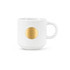 A ceramic mug in white with a textured design and a bronze medal feature on the front.