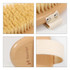 A sisal wooden brush with a natural bristle head and a cream-coloured fabric strap, featuring a wooden handle and branding.