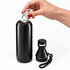 A drink bottle in matte black with a removable cap, being filled with ice cubes. It includes a smaller, attachable bottle.