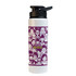 A drink bottle in white with a purple design featuring various illustrated faces. It has a black spout and lid.