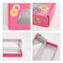 A large, pink gift box with a rectangular window, featuring colourful donut graphics and a glossy interior.