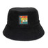 A black terry towelling bucket hat featuring a colourful patch with a hiking theme.