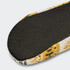 A pair of custom knitted slippers featuring a patterned knit design in yellow and white, with a textured black sole.