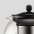A black and silver tea press with a rounded glass body and a large round knob on the lid, featuring a stainless steel infuser.