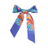 A satin narrow scarf in vibrant blue with a tropical floral design, featuring a large bow shape.