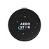 A round, black compact with a starry design and a logo in the centre.