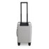A silver carry-on suitcase with a retractable handle and wheels, featuring a simple design and a logo.