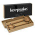 Wooden salad servers presented in a stylish box, featuring a fork and spoon design. The packaging has a logo.