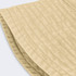 A beige bucket hat with a textured fabric and a wide brim, featuring a logo on the side.