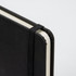 A4 daily diary in black with an elastic band closure and rounded corners. Features a textured cover and plain pages.
