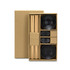 A keepsake sushi set featuring wooden chopsticks, black ceramic bowls, and soy sauce dishes in a cardboard box.