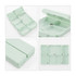 A light green folding pill box with seven compartments, featuring a small button for secure closure.