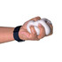 A hand gripping a white squishy stress toy, with a black wristwatch visible on the wrist.