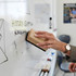 A wooden whiteboard eraser with a black felt bottom being used to clean a whiteboard.