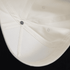 A two-tone cap in white and black, featuring an interior view showing its structured design and a logo.