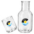 A glass carafe and cup set in clear glass, featuring a logo, with a sleek design.