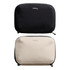 A black and a beige tech kit with zippers, both featuring a logo on the front.