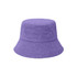 A purple reversible bucket hat made of dual materials, featuring a textured surface and a branded logo.
