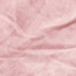 A close-up of soft, pink velvet fabric with subtle texture and creases.