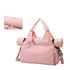 A pink duffle bag with a yoga mat strap, featuring a large main compartment and adjustable shoulder strap.