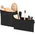 A set of two black toiletry bags filled with various grooming products, including a hairbrush, lotion, and toothbrushes.