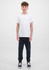 A young person is wearing navy track pants and a plain white t-shirt, standing against a light background.