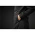 A black softshell jacket featuring a zippered front and side pockets, with a hand placed in one of the pockets.
