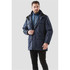 A man models a dark blue Men's Fairbanks 5-in-1 System Jacket with multiple pockets and a detachable inner layer.