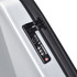 A close-up of a silver expandable hardshell backpack featuring a black zipper and a combination lock.