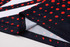 A unisex football jersey featuring a navy background with red dots and white stripes, showcasing a logo on the fabric.