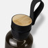 A drink bottle in dark green with a black lid and a bamboo top, featuring a looped handle.
