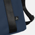 A soft-touch cooler bag in navy blue with a black strap and a small logo on the side.
