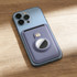 A lavender PU magnetic card and Airtag holder attached to a blue smartphone on a wooden surface.