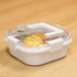 A white lunch box with a clear lid, featuring a green logo and a secure clip closure.